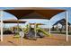 Vibrant community playground with slides, climbing structures, and covered seating at 32243 N Garnet Way, San Tan Valley, AZ 85143