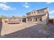 Spacious backyard with desert landscaping, showcasing home's exterior, patio, and a trampoline at 3394 E Tiffany Ct, Gilbert, AZ 85298