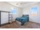 Cozy bedroom with neutral carpet, a ceiling fan, and two windows providing natural light at 3394 E Tiffany Ct, Gilbert, AZ 85298