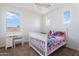 Bright bedroom with large windows, neutral walls, ceiling fan, and a bed with colorful bedding at 3394 E Tiffany Ct, Gilbert, AZ 85298
