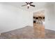 Bedroom offering natural light, neutral walls, ceiling fan, and partial view of the modern kitchen at 3394 E Tiffany Ct, Gilbert, AZ 85298