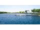 A tranquil lake with a fishing pier offering picturesque views and recreational opportunities at 3394 E Tiffany Ct, Gilbert, AZ 85298