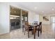 Bright dining nook features a table for four and sliding glass doors to the screened in outdoor seating at 3394 E Tiffany Ct, Gilbert, AZ 85298