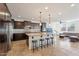 Spacious kitchen featuring a large island with seating, modern appliances, and dark wood cabinets at 3394 E Tiffany Ct, Gilbert, AZ 85298