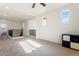 Bright loft area with plush carpeting, neutral walls, modern ceiling fan, and natural light at 3394 E Tiffany Ct, Gilbert, AZ 85298