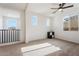 Carpeted loft with a view of the mountains from the windows and black furniture and a ceiling fan at 3394 E Tiffany Ct, Gilbert, AZ 85298