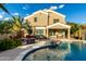 Large backyard with a sparkling pool, covered patio, desert landscaping and a beautiful home exterior at 3634 S Danielson Way, Chandler, AZ 85286