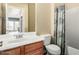Bright bathroom featuring a vanity with a white sink, toilet, and tub with patterned shower curtain at 3634 S Danielson Way, Chandler, AZ 85286