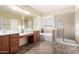 Bright bathroom with double vanity, separate tub and shower, and tiled floors, offering a luxurious and functional space at 3634 S Danielson Way, Chandler, AZ 85286