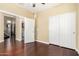 Bedroom with hardwood floors and a large closet with white doors at 3634 S Danielson Way, Chandler, AZ 85286
