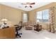 Cozy bedroom featuring a ceiling fan, large window, and comfortable seating, perfect for relaxing and unwinding at 3634 S Danielson Way, Chandler, AZ 85286