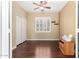 Bedroom with hardwood floors, shuttered windows and a desk with printer at 3634 S Danielson Way, Chandler, AZ 85286