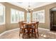 Charming dining room with wood table, shuttered windows and elegant chandelier, creating a warm, inviting space at 3634 S Danielson Way, Chandler, AZ 85286