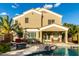 Spacious home exterior featuring a covered patio, a pool, and lush landscaping with trees at 3634 S Danielson Way, Chandler, AZ 85286