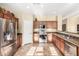 Bright kitchen with stainless steel appliances, wooden cabinetry, and tile flooring, providing a modern and functional space at 3634 S Danielson Way, Chandler, AZ 85286