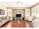 Inviting living room with hardwood floors, modern decor, and plantation shutters at 3634 S Danielson Way, Chandler, AZ 85286