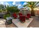 Outdoor seating area with a fire pit, complete with gravel and desert landscaping under a bright sky at 3634 S Danielson Way, Chandler, AZ 85286