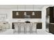 Modern kitchen with stainless steel appliances, dark cabinetry, and barstool seating at 3738 E Gold Mountain Ave, San Tan Valley, AZ 85143