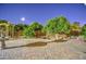 Tranquil backyard featuring a water feature, custom pergola, and mature trees for added privacy at 3753 E Ellis St, Mesa, AZ 85205