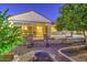 A beautiful backyard with brickwork, landscaping, and a large glass window showcasing the interior at 3753 E Ellis St, Mesa, AZ 85205