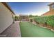 The backyard boasts a putting green, BBQ island, and privacy landscaping at 3753 E Ellis St, Mesa, AZ 85205
