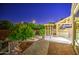 Lush backyard oasis featuring a custom pergola, mature trees, and spa at 3753 E Ellis St, Mesa, AZ 85205