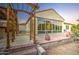 Paver patio with an arbor, rock detail, and large windows enhance this home's outdoor living space at 3753 E Ellis St, Mesa, AZ 85205