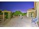 Serene backyard with a custom pergola, lush greenery, and a charming water feature at 3753 E Ellis St, Mesa, AZ 85205