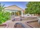 Backyard with brickwork planters and privacy landscaping seen from the patio with large glass windows at 3753 E Ellis St, Mesa, AZ 85205