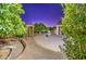 Lush backyard oasis with a custom pergola, mature trees, and a tranquil water feature at 3753 E Ellis St, Mesa, AZ 85205