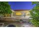 Charming backyard with lush citrus trees, brick patio, and a tranquil water feature at 3753 E Ellis St, Mesa, AZ 85205