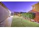 Backyard putting green with a covered bar and privacy landscaping, perfect for outdoor entertaining at 3753 E Ellis St, Mesa, AZ 85205