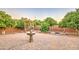 Backyard oasis with a decorative fountain, mature trees, and a brick-paved patio for outdoor entertaining at 3753 E Ellis St, Mesa, AZ 85205