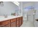 Spacious bathroom featuring double sinks, updated fixtures, and a glass-enclosed shower with accessible handrails at 3753 E Ellis St, Mesa, AZ 85205