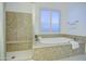 Luxurious bathroom showcasing a soaking tub and a tiled walk-in shower at 3753 E Ellis St, Mesa, AZ 85205