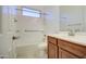 Bathroom with a tub and shower combination featuring updated fixtures and a wood vanity with a white countertop at 3753 E Ellis St, Mesa, AZ 85205