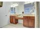Bright bathroom featuring dual sinks, granite countertops, and a large mirror at 3753 E Ellis St, Mesa, AZ 85205