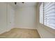 Bedroom featuring carpet flooring, neutral walls, window and door at 3753 E Ellis St, Mesa, AZ 85205