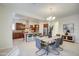 Open dining area features modern table and chairs with a view of the kitchen and stainless steel appliances at 3753 E Ellis St, Mesa, AZ 85205