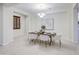 Elegant dining room featuring modern chandelier, sleek table set for six, and decorative artwork at 3753 E Ellis St, Mesa, AZ 85205