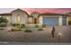 Charming single-story home featuring well-manicured desert landscaping and a three-car garage at 3753 E Ellis St, Mesa, AZ 85205