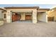Three car garage with custom cabinetry, overhead lighting, and a brick paver driveway at 3753 E Ellis St, Mesa, AZ 85205