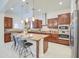 Gourmet kitchen featuring an island with seating, stainless steel appliances, and dark wood cabinetry at 3753 E Ellis St, Mesa, AZ 85205