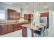 Gourmet kitchen features rich wood cabinets, granite countertops, stainless appliances, and a large center island at 3753 E Ellis St, Mesa, AZ 85205