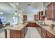 Spacious kitchen with stainless steel appliances, granite counters, breakfast bar island, and modern cabinetry at 3753 E Ellis St, Mesa, AZ 85205