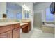 Elegant main bathroom with dual sinks, soaking tub, tiled shower, and designer fixtures at 3753 E Ellis St, Mesa, AZ 85205