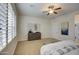 Relaxing main bedroom features plantation shutters, a ceiling fan, neutral color palette, and dresser at 3753 E Ellis St, Mesa, AZ 85205