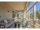 Inviting sunroom with plush seating, a stylish coffee table, and large windows offering natural light at 3753 E Ellis St, Mesa, AZ 85205
