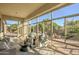 Bright sunroom with floor-to-ceiling windows, comfortable seating, and views of the surrounding landscape at 3753 E Ellis St, Mesa, AZ 85205