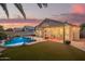 Backyard with a sparkling pool, outdoor seating, and landscaped green space, great for entertaining at 3971 E Heather Ct, Gilbert, AZ 85234